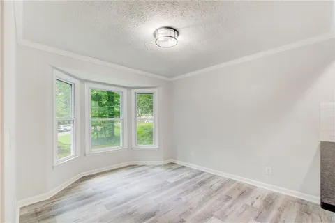 a view of a kitchen with a sink and wooden floor