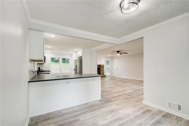 a kitchen with stainless steel appliances granite countertop a stove a microwave and cabinets