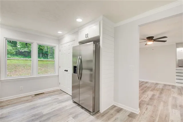 an empty room with a fireplace and window