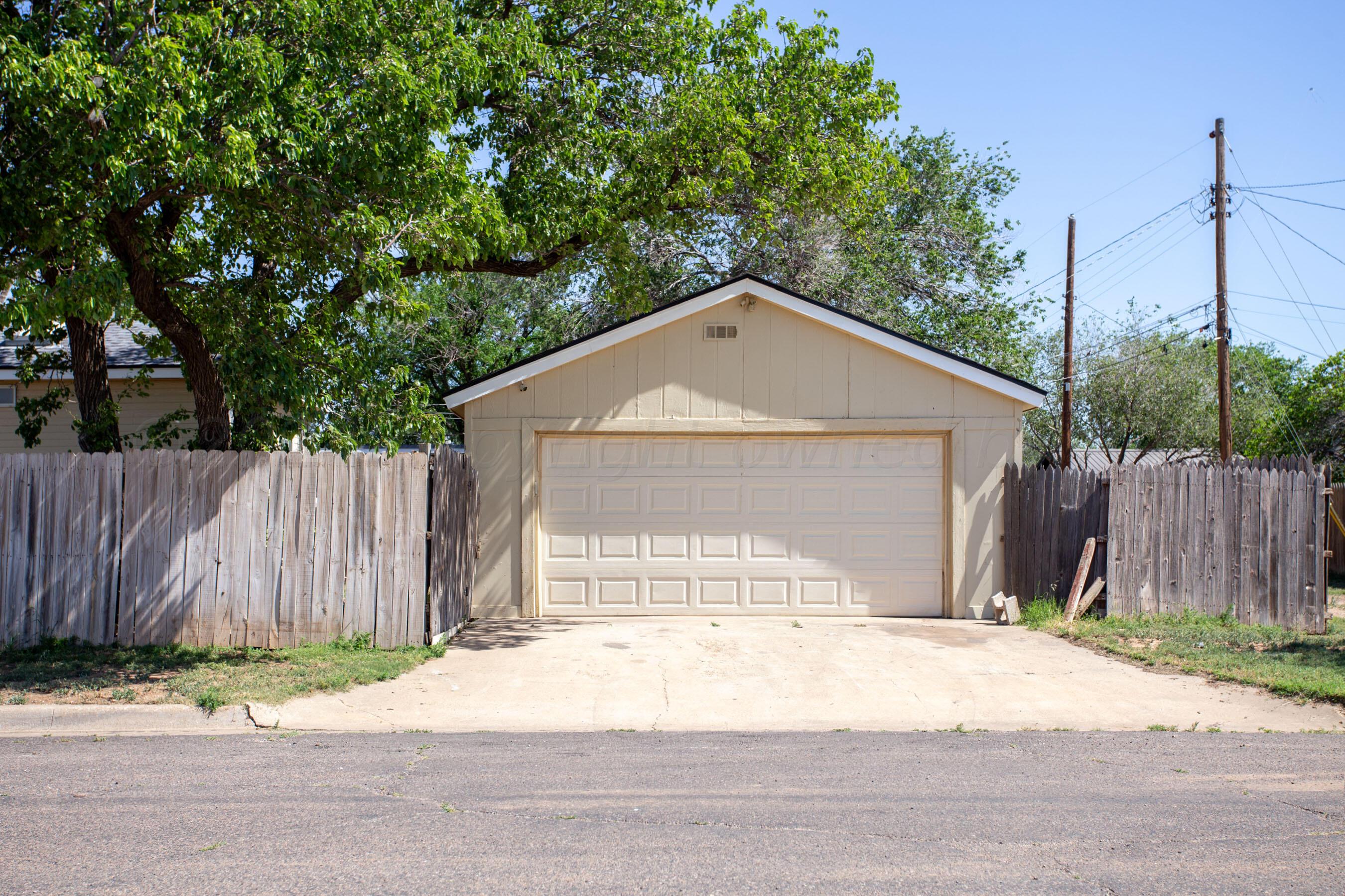 4625 South Travis Street Amarillo, TX 79110 - Photo 22 of 24 a front view of a house with a yard and garage