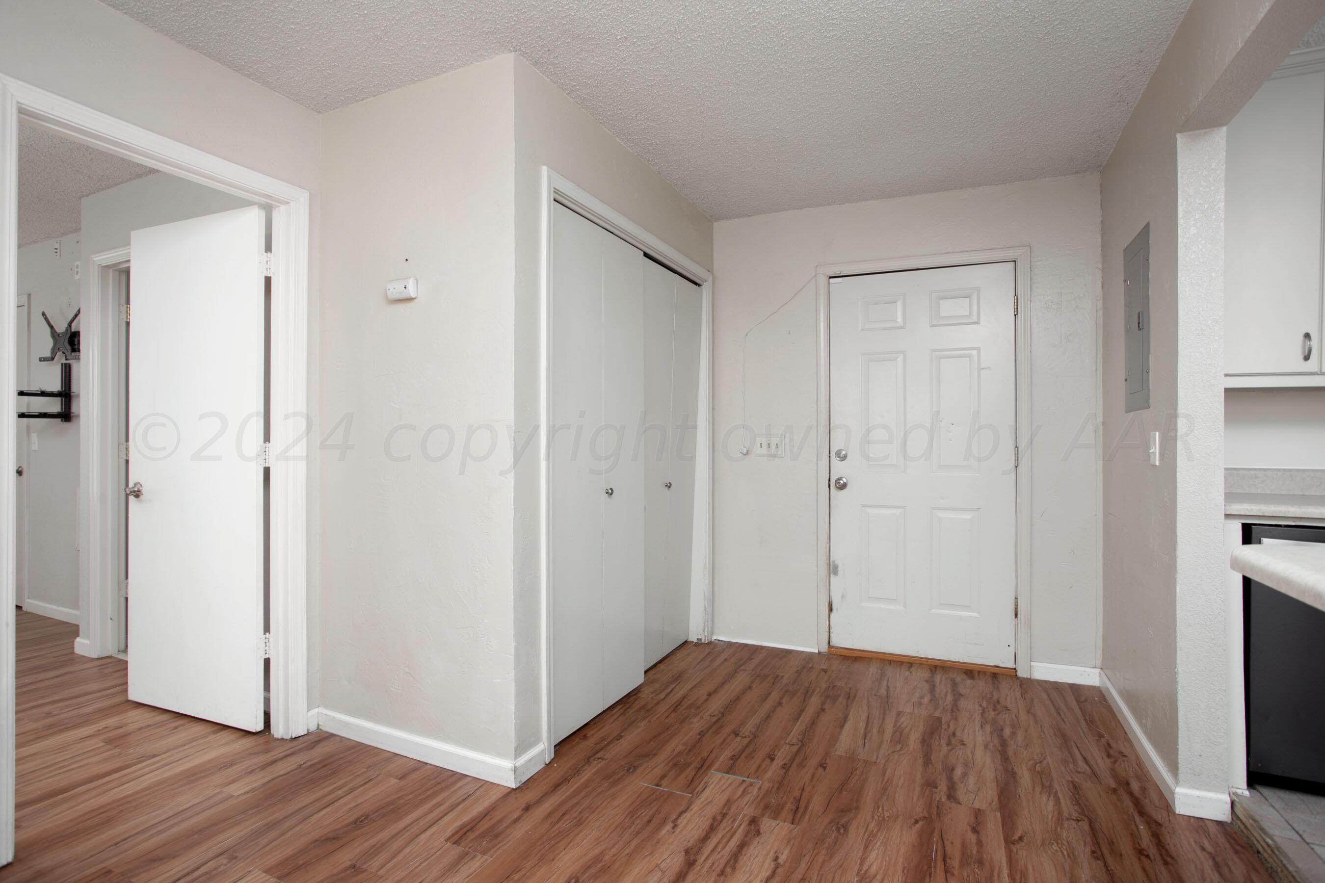 4625 South Travis Street Amarillo, TX 79110 - Photo 10 of 24 wooden floor in an empty room