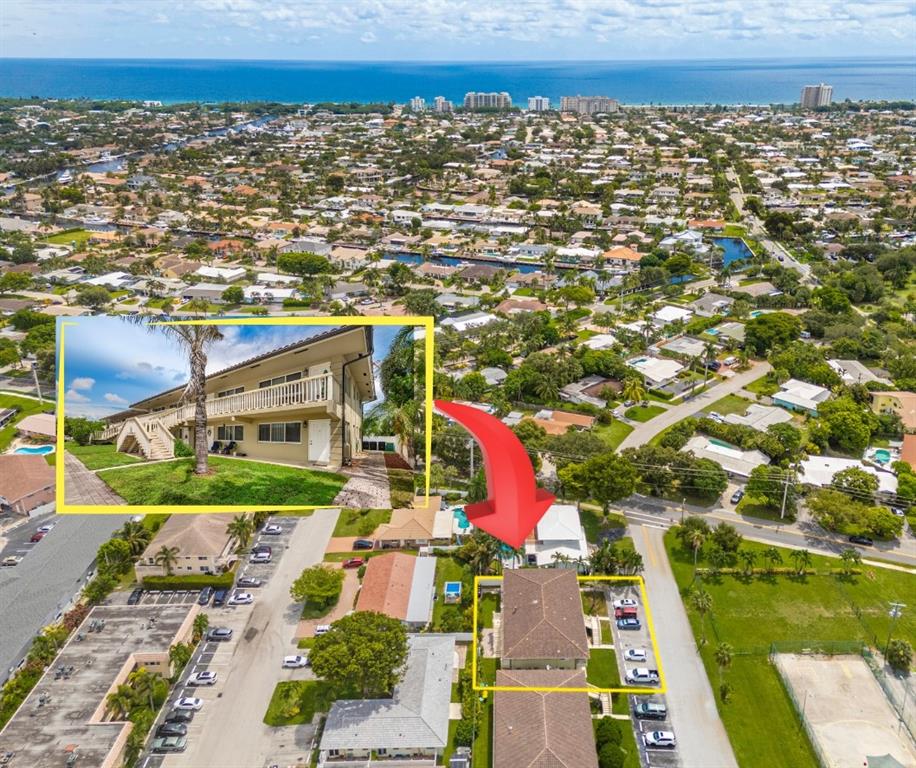 an aerial view of residential houses with outdoor space and swimming pool