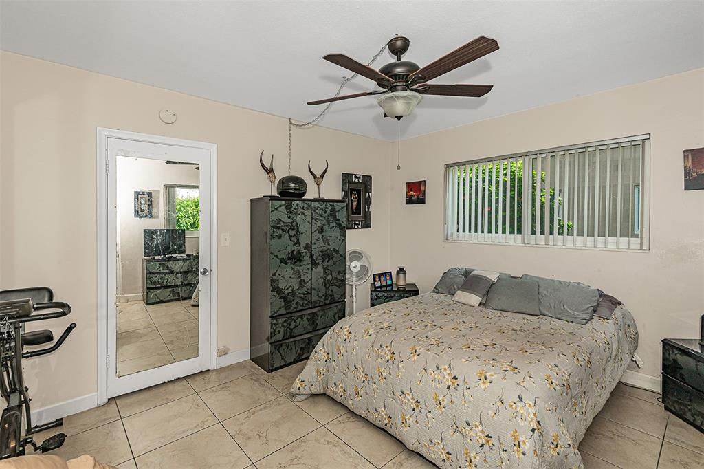 2131 Northeast 40th Court Lighthouse Point, FL 33064 - Photo 19 of 32 a bedroom with a large bed and a window
