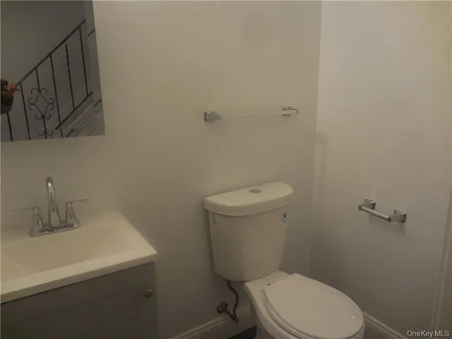 a white toilet sitting next to a bathroom sink