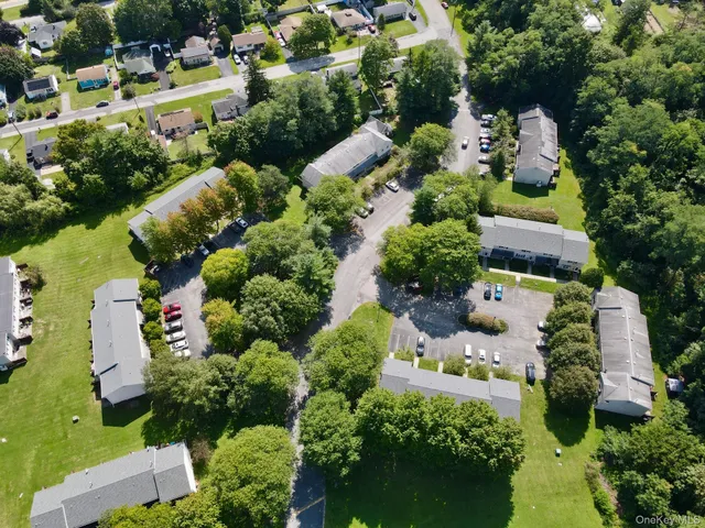 an aerial view of a house with a yard and outdoor seating