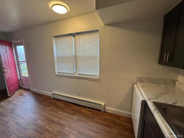 a view of a kitchen with wooden floor and a sink