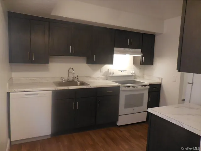 a kitchen with wooden cabinets and sink