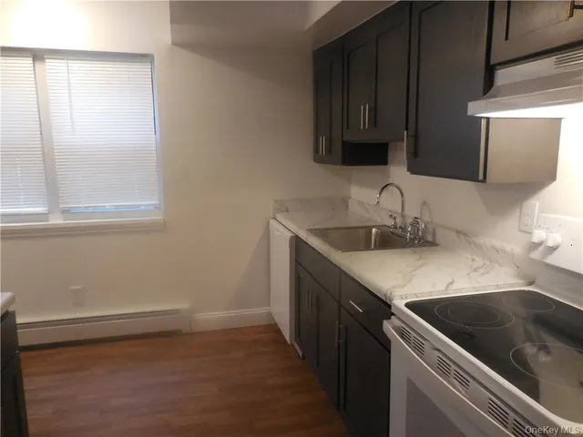 a kitchen with a sink and a stove top oven