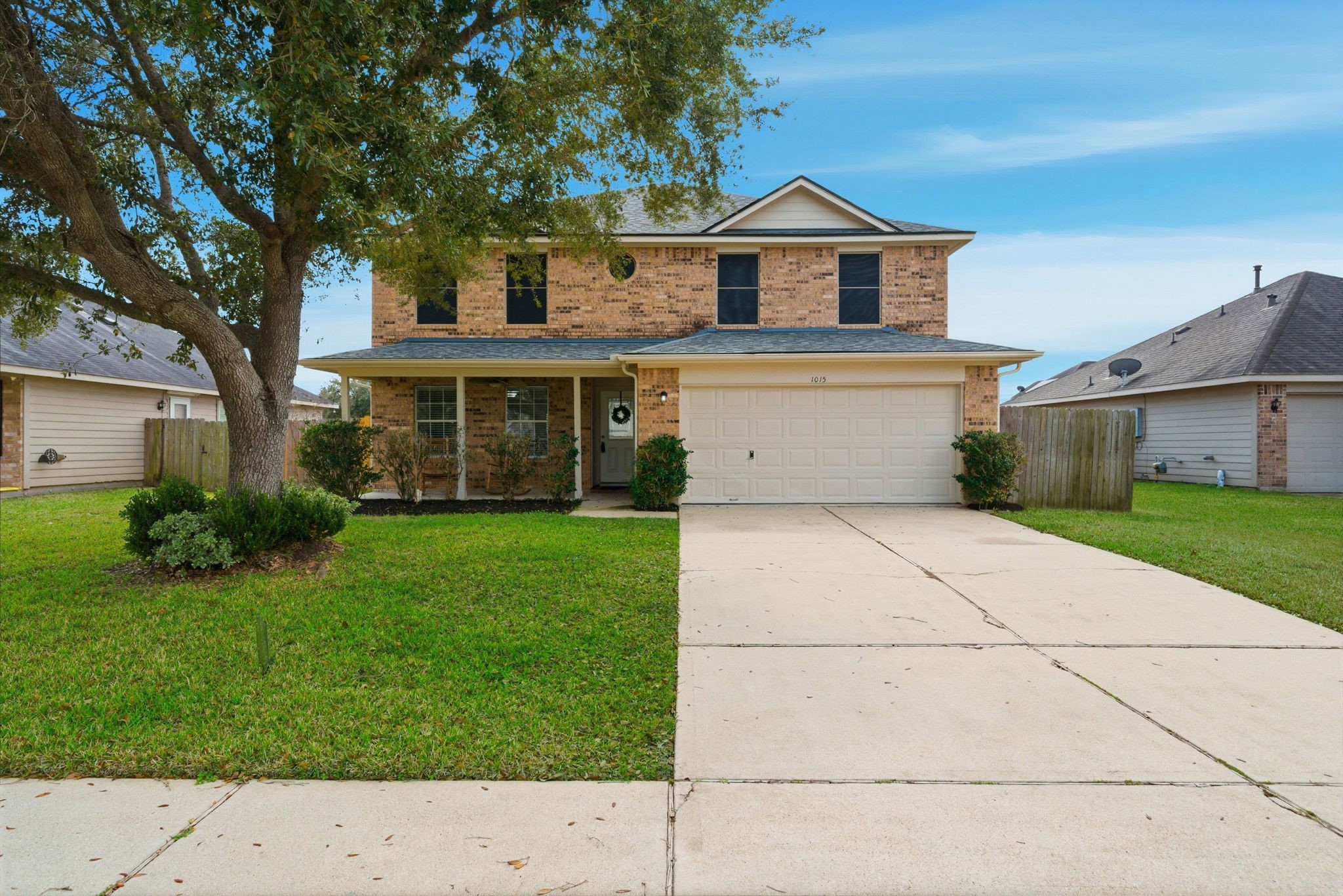 a front view of a house with a yard and trees