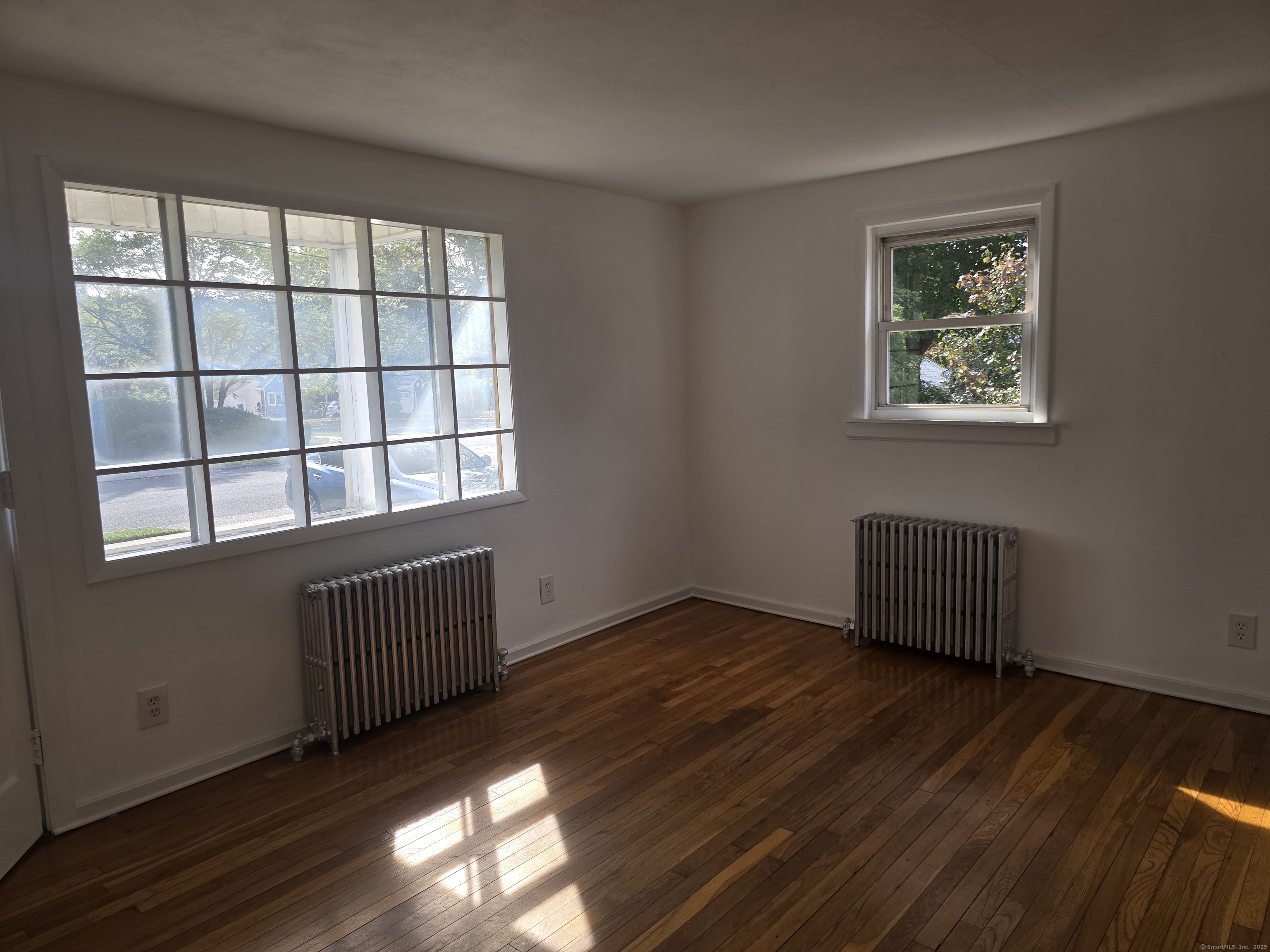 1 Murray Avenue Shelton, CT 06484 - Photo 2 of 4 a view of an empty room with wooden floor and a window