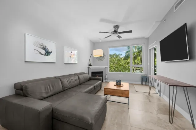 a living room with furniture a fireplace and a flat screen tv