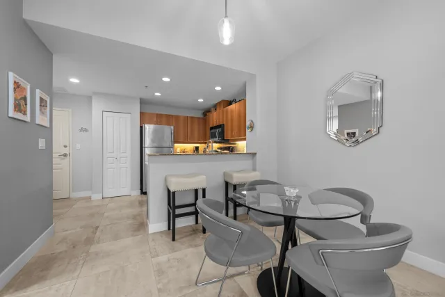 a kitchen with a dining table chairs and view of kitchen