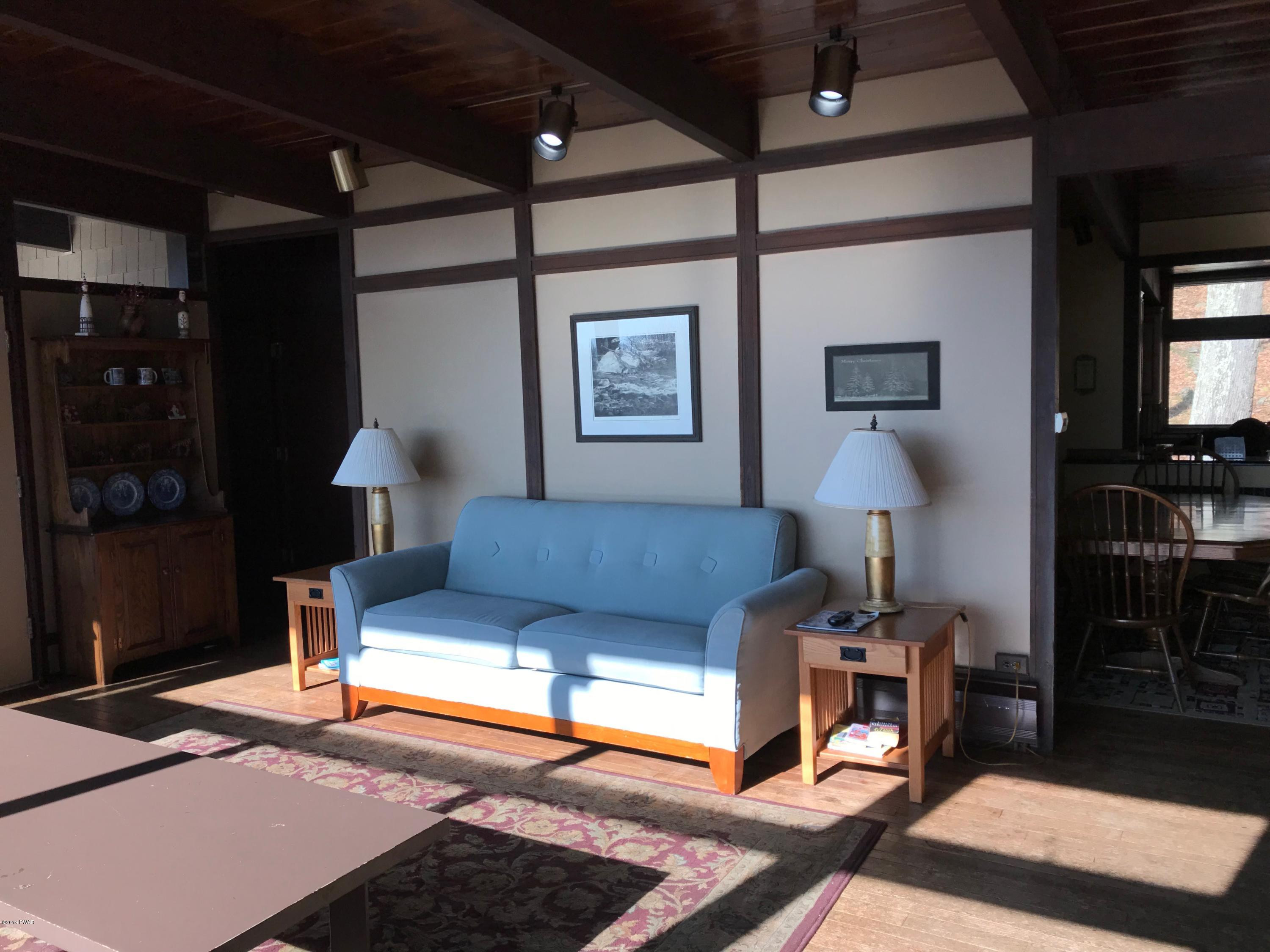 819 Wargo Road Union Dale, PA 18470 - Photo 8 of 49 a living room with furniture a lamp and a rug