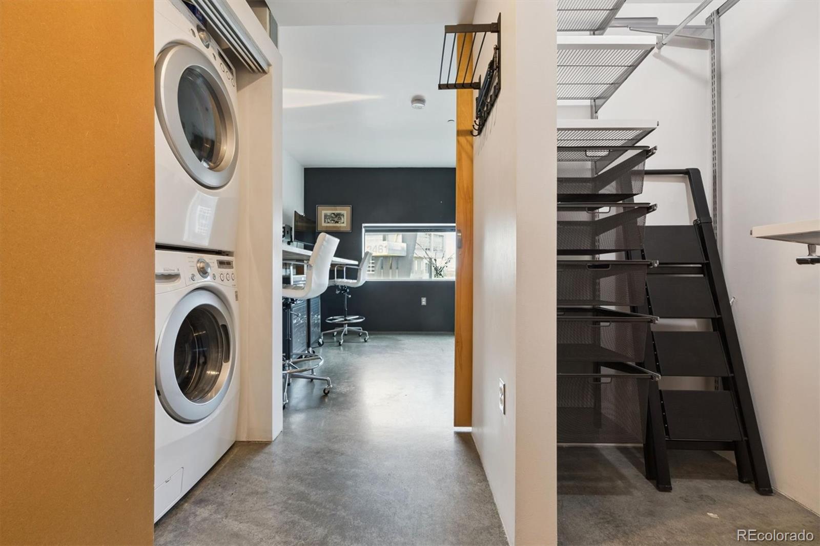 3457 Ringsby Court, Unit 304 Denver, CO 80216 - Photo 15 of 28 a utility room with dryer and washer