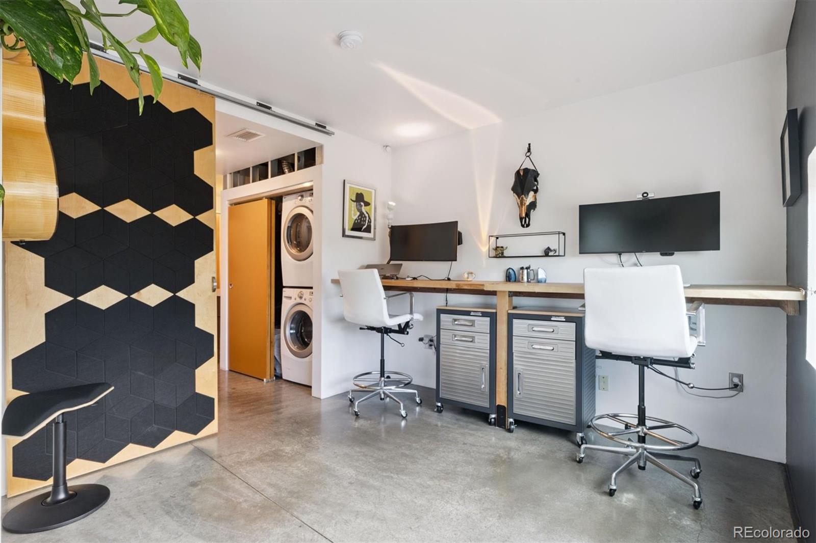 3457 Ringsby Court, Unit 304 Denver, CO 80216 - Photo 16 of 28 a view of a workspace with furniture and a fireplace
