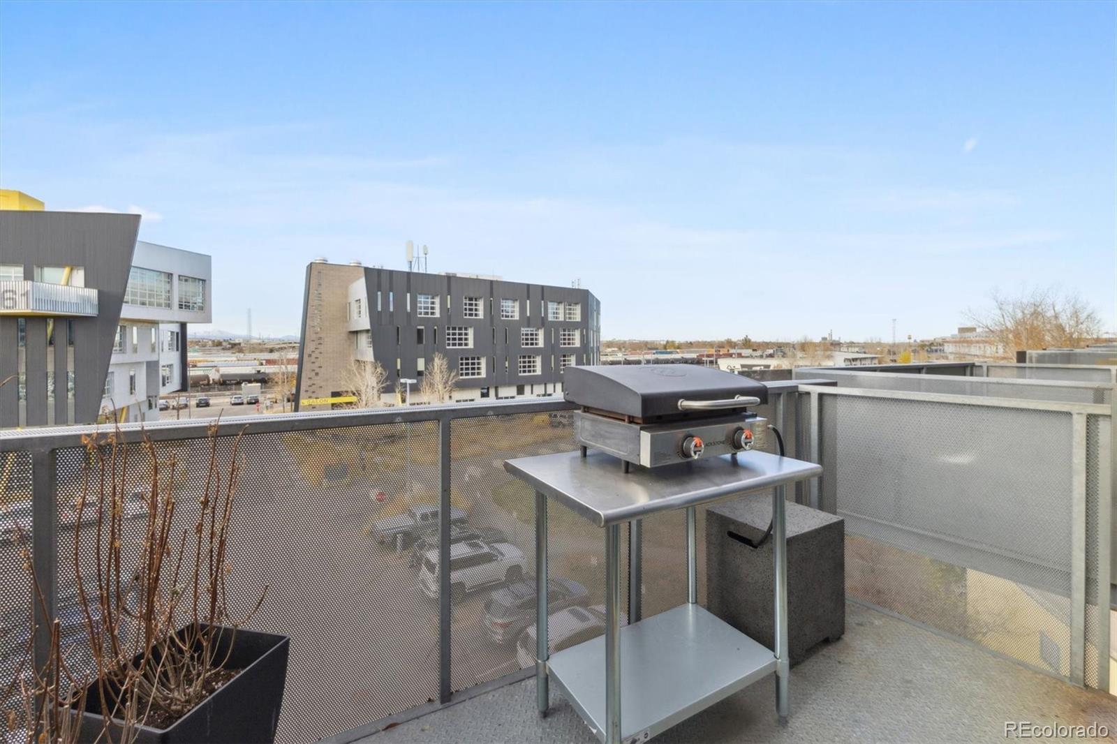 3457 Ringsby Court, Unit 304 Denver, CO 80216 - Photo 20 of 28 a view of a chairs and table in a balcony