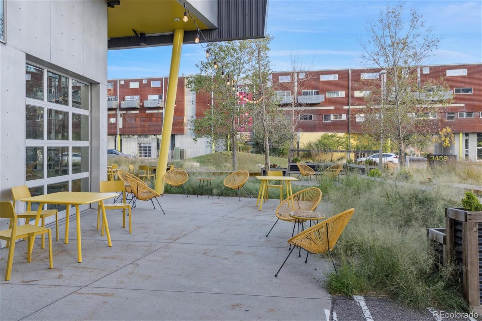 3457 Ringsby Court, Unit 304 Denver, CO 80216 - Photo 22 of 28 a view of a lake with a barbeque and sitting area