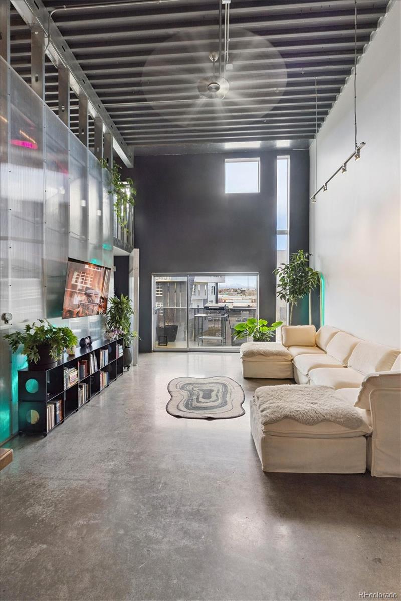 3457 Ringsby Court, Unit 304 Denver, CO 80216 - Photo 4 of 28 a living room with furniture and a fireplace