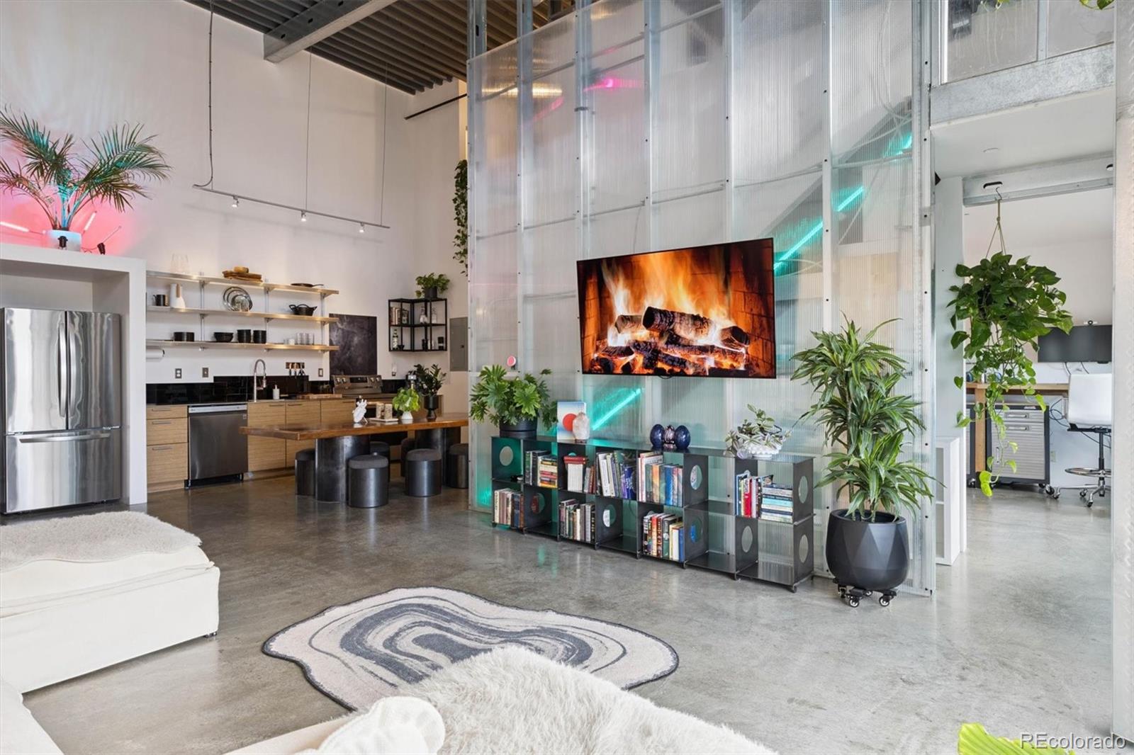 3457 Ringsby Court, Unit 304 Denver, CO 80216 - Photo 8 of 28 a living room with furniture and a flat screen tv