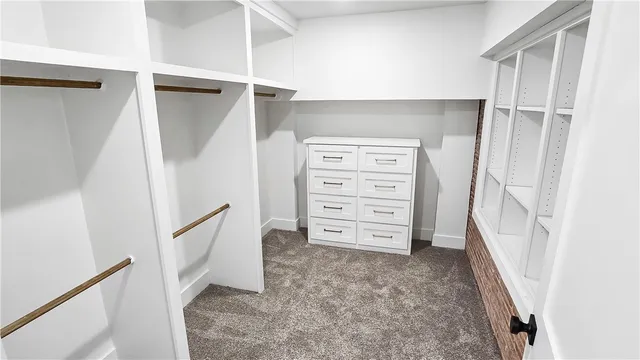 a view of walk in closet with clothes