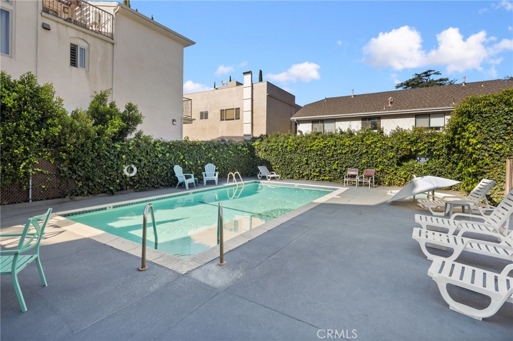 10757 Hortense, Unit 307 North Hollywood, CA 91602 - Photo 15 of 21 a view of a patio with a table and chairs and potted plants
