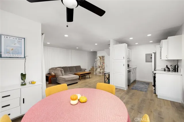 a living room with furniture and kitchen view