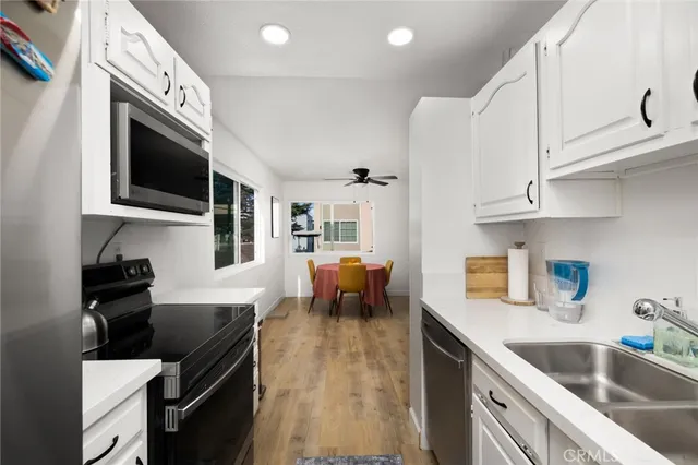 a kitchen with a sink cabinets and window