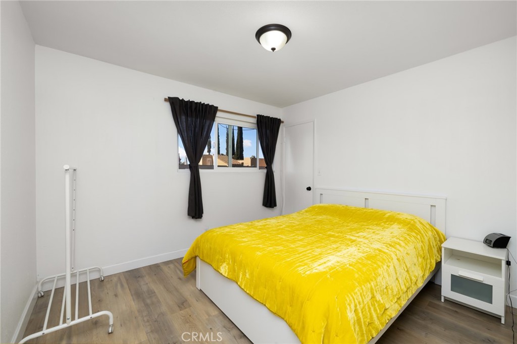 10757 Hortense, Unit 307 North Hollywood, CA 91602 - Photo 9 of 21 a bed sitting in a room next to a window