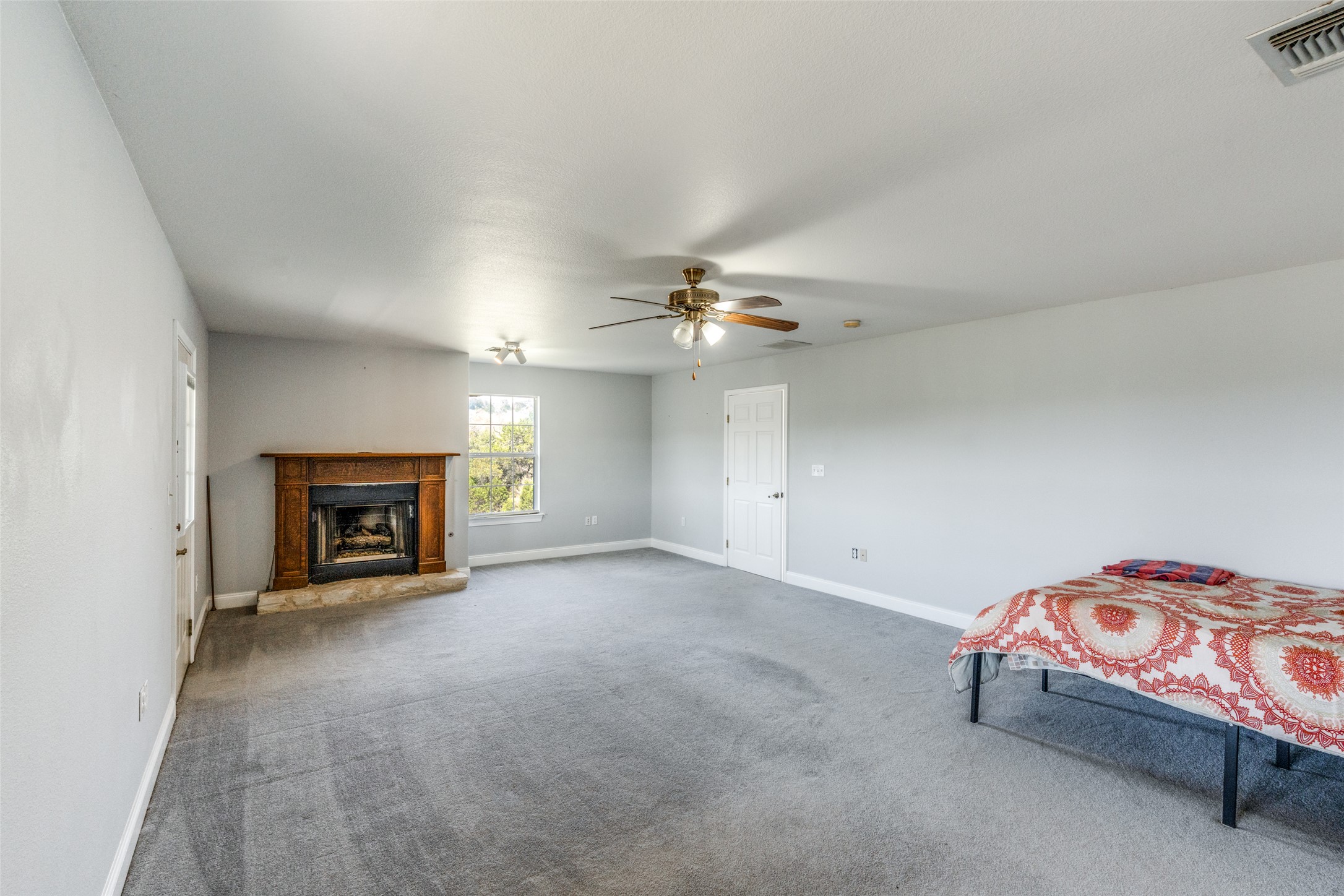 34970 Smithson Valley Road Bulverde, TX 78163 - Photo 12 of 36 a view of a livingroom with a fireplace and a chandelier