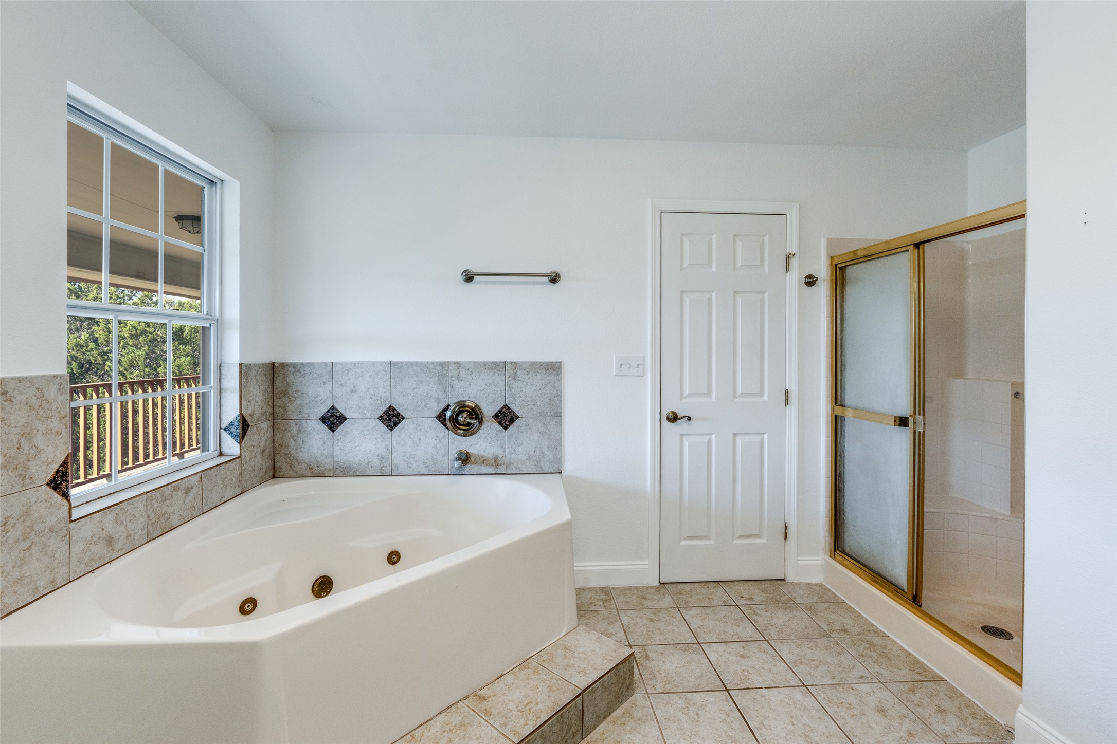 34970 Smithson Valley Road Bulverde, TX 78163 - Photo 13 of 36 a bathroom with a bathtub and a shower