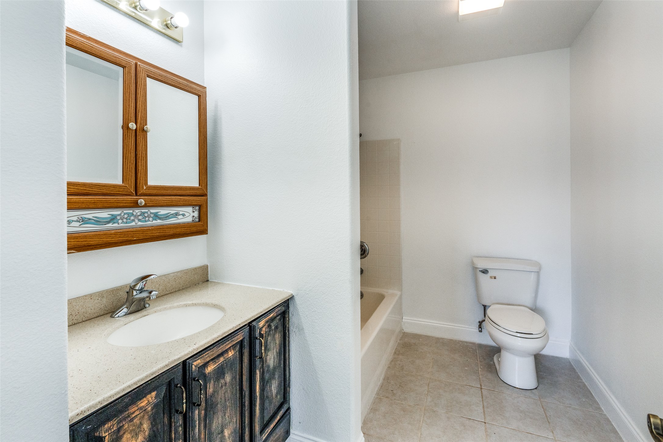34970 Smithson Valley Road Bulverde, TX 78163 - Photo 17 of 36 a bathroom with a sink vanity mirror and toilet