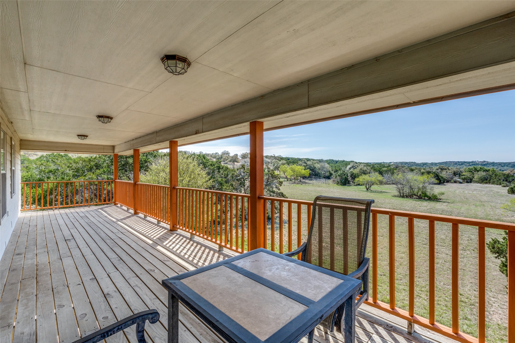 34970 Smithson Valley Road Bulverde, TX 78163 - Photo 21 of 36 a view of balcony with wooden floor and outdoor seating