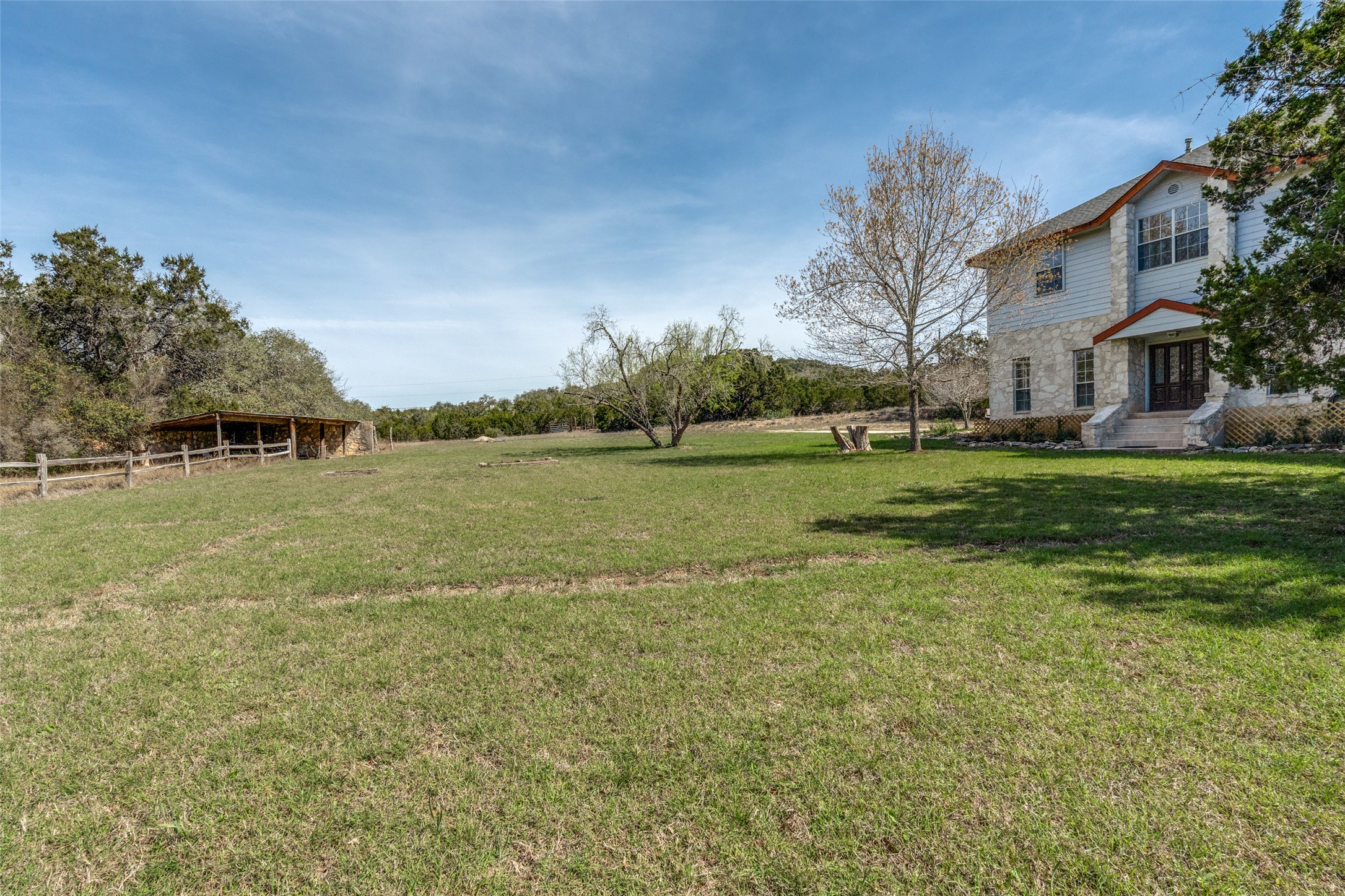 34970 Smithson Valley Road Bulverde, TX 78163 - Photo 6 of 36 a view of a field with a house in the background