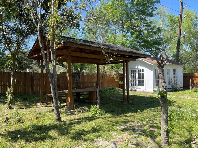a backyard of a house with barbeque oven