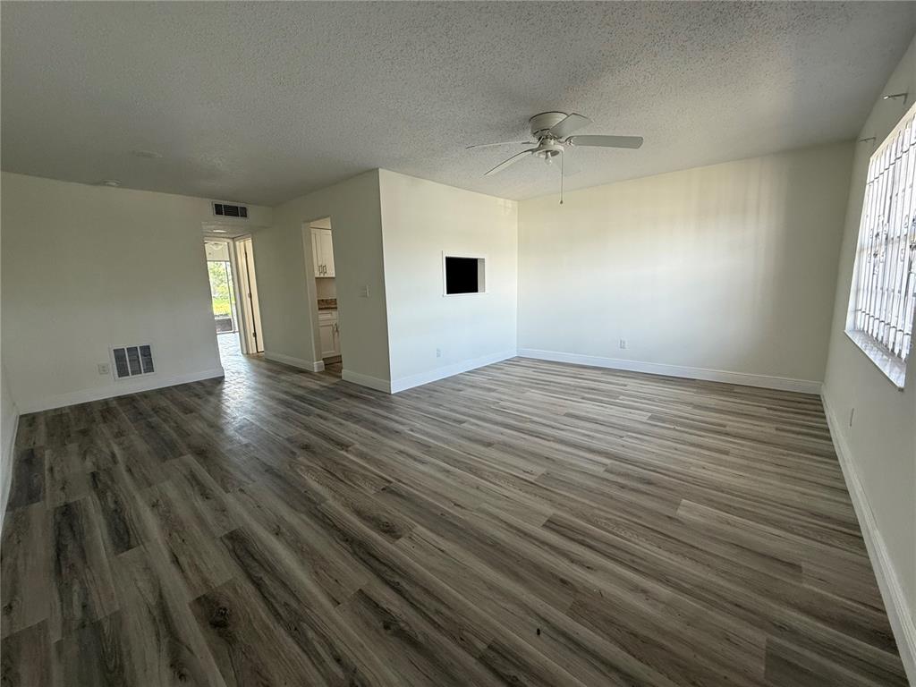 9209 Tudor Drive, Unit C102 Tampa, FL 33615 - Photo 3 of 8 an empty room with wooden floor and windows
