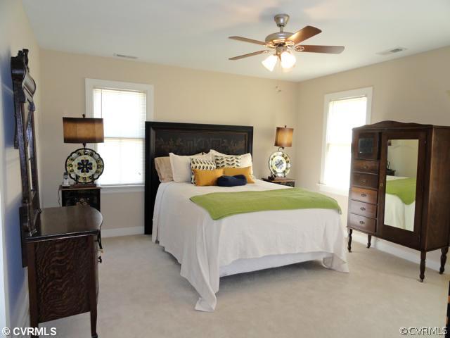832 Club Ridge Court Chester, VA 23836 - Photo 8 of 12 a bedroom with a bed and a chandelier