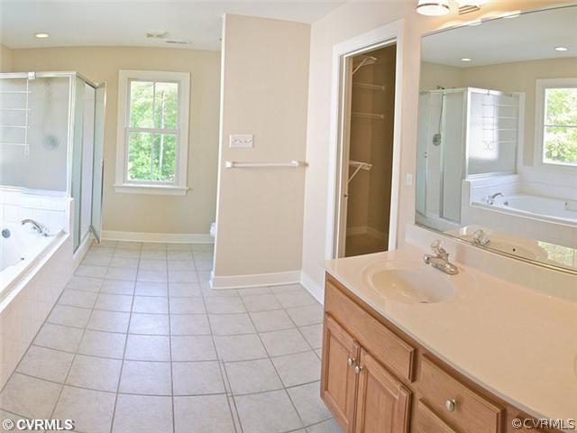 832 Club Ridge Court Chester, VA 23836 - Photo 9 of 12 a spacious bathroom with a shower sink and mirror
