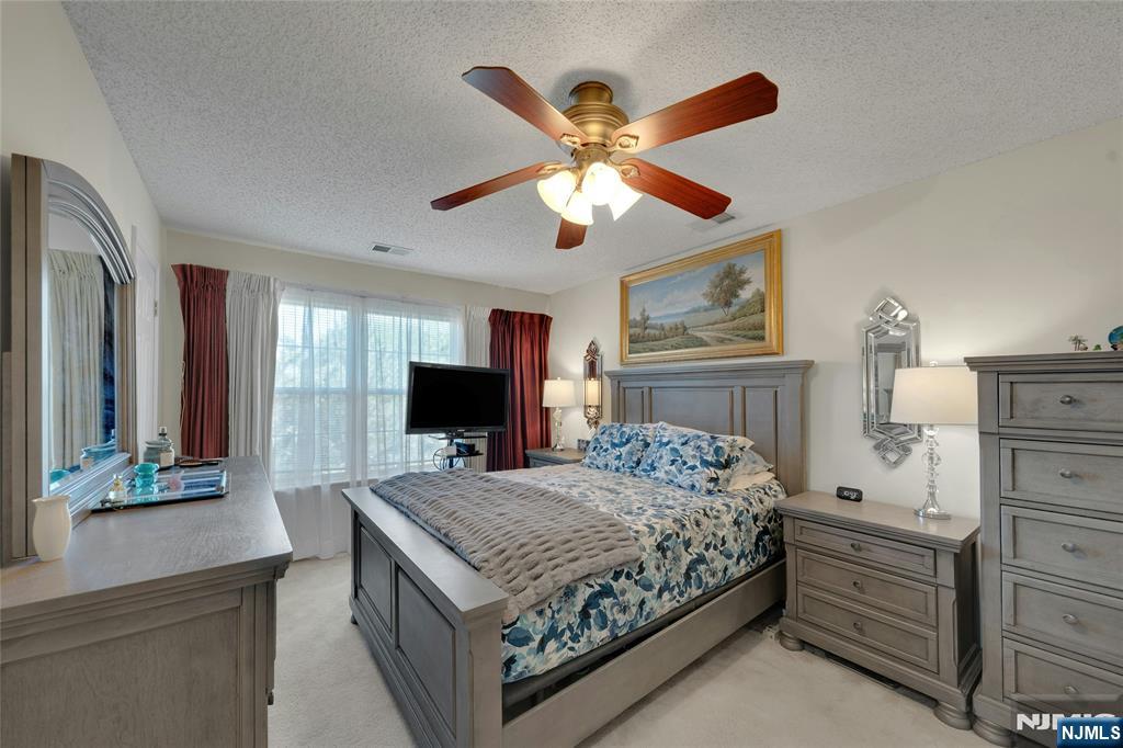 72 Marrow Street, Unit 3101 Newark, NJ 07103 - Photo 13 of 20 a bedroom with a bed and a chandelier