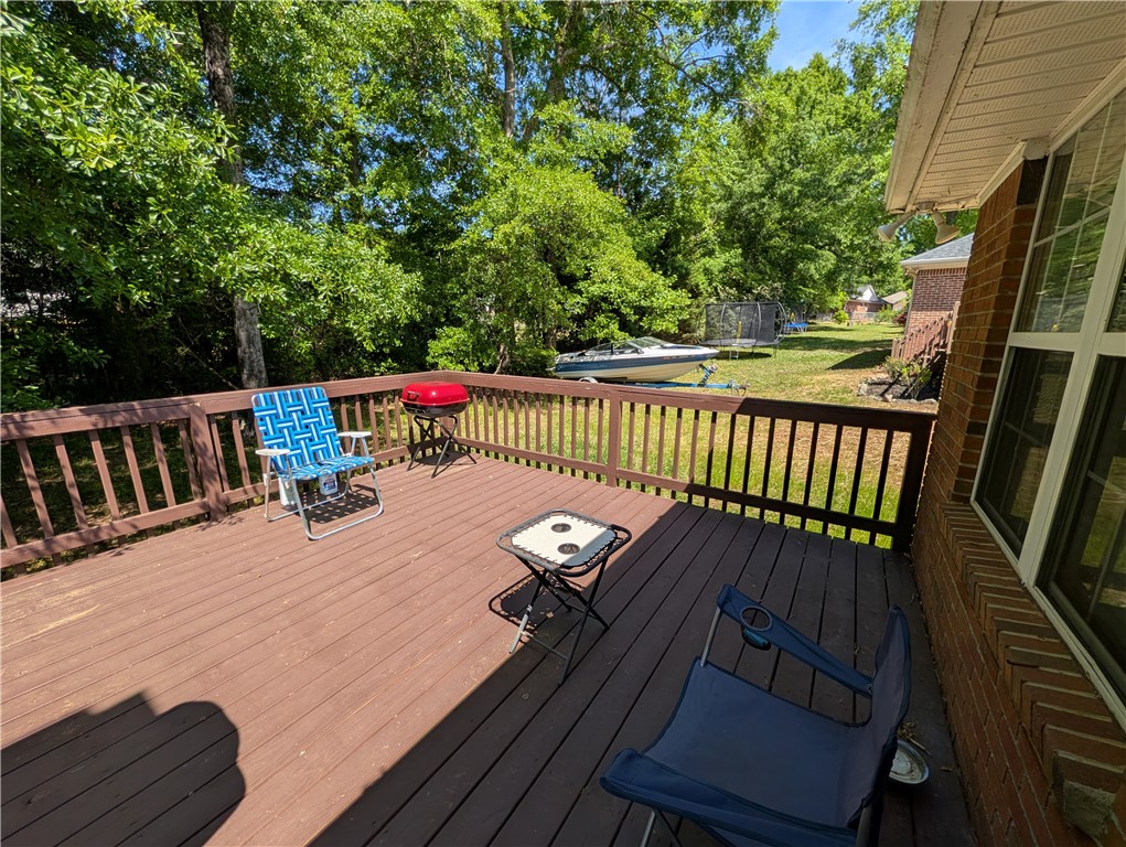 124 Woodbridge Court Anderson, SC 29621 - Photo 7 of 15 This outdoor deck provides a private space for relaxation and entertaining, surrounded by lush greenery.