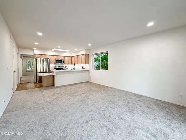 a view of a kitchen with a sink and cabinets