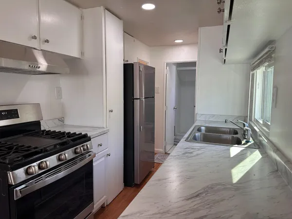 a kitchen with stainless steel appliances a stove and a refrigerator