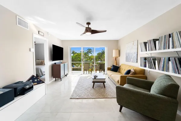 a living room with furniture tv and a large window