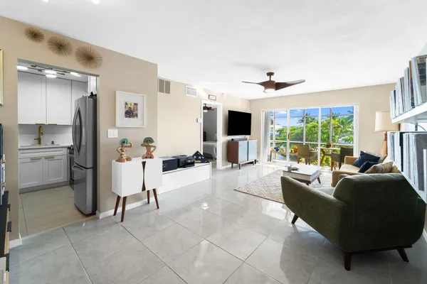 a living room with furniture and large windows