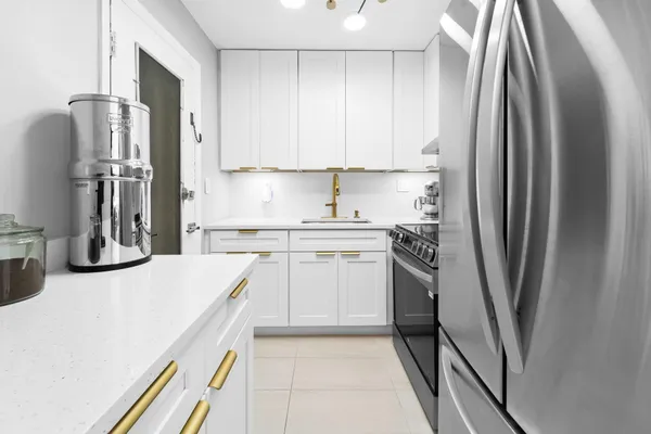 a kitchen with stainless steel appliances a refrigerator sink and stove