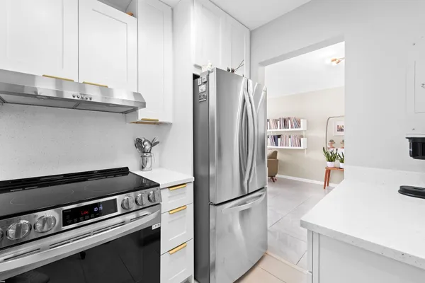a kitchen with stainless steel appliances a refrigerator and a stove