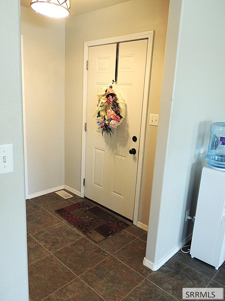 27 North White Pne Lane Rigby, ID 83442 - Photo 13 of 25 Primary bedroom w view to primary bath door
