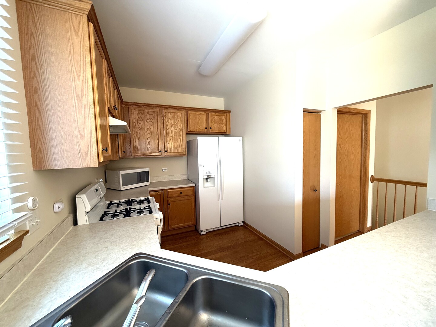 1604 Augusta Lane Shorewood, IL 60404 - Photo 11 of 32 a kitchen with a refrigerator and a sink