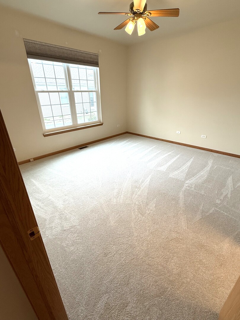 1604 Augusta Lane Shorewood, IL 60404 - Photo 15 of 32 an empty room with windows