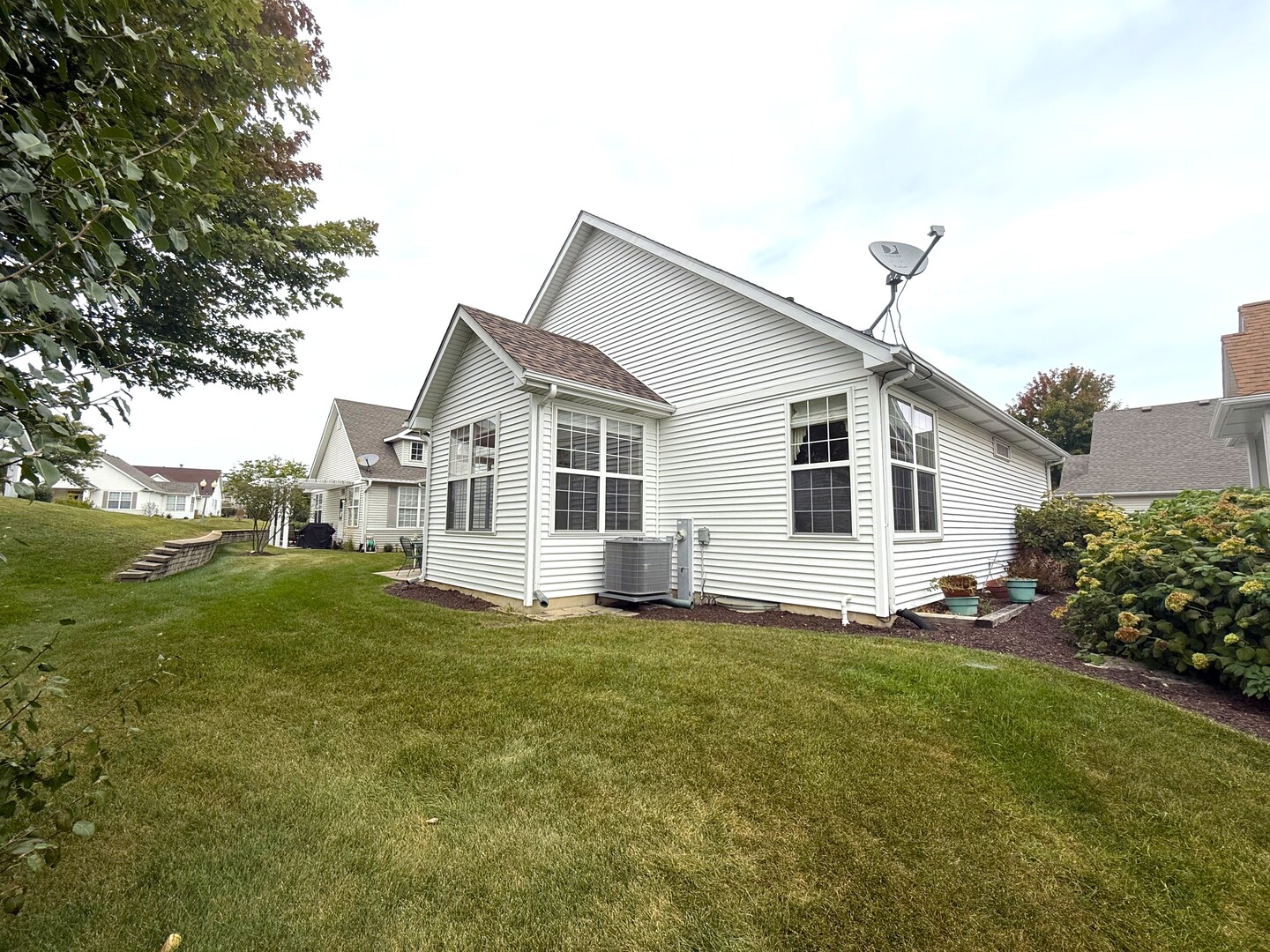1604 Augusta Lane Shorewood, IL 60404 - Photo 23 of 32 a view of a yard in front of a house with plants and large tree