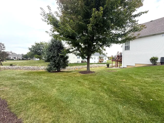 a view of green field with trees around